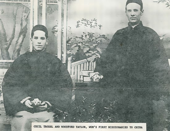 Two young men sitting together facing the camera